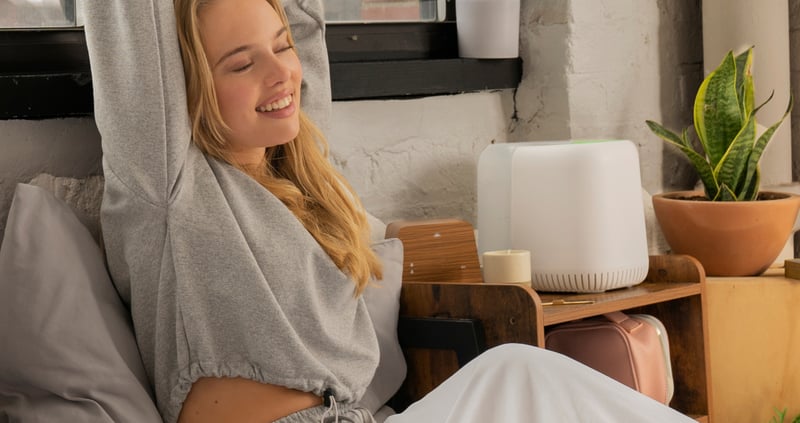 canopy - woman sitting in bed stretching her arms above her head