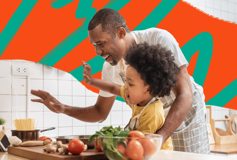 photo of man in kitchen with child in kitchen cooking